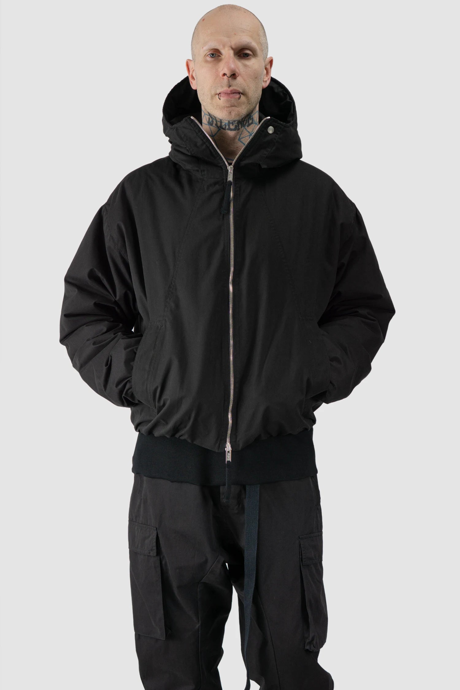 Thom Krom - model relaxed view of men’s Black Padded Short Jacket with Magnetic Buckle Hoody M-J-74