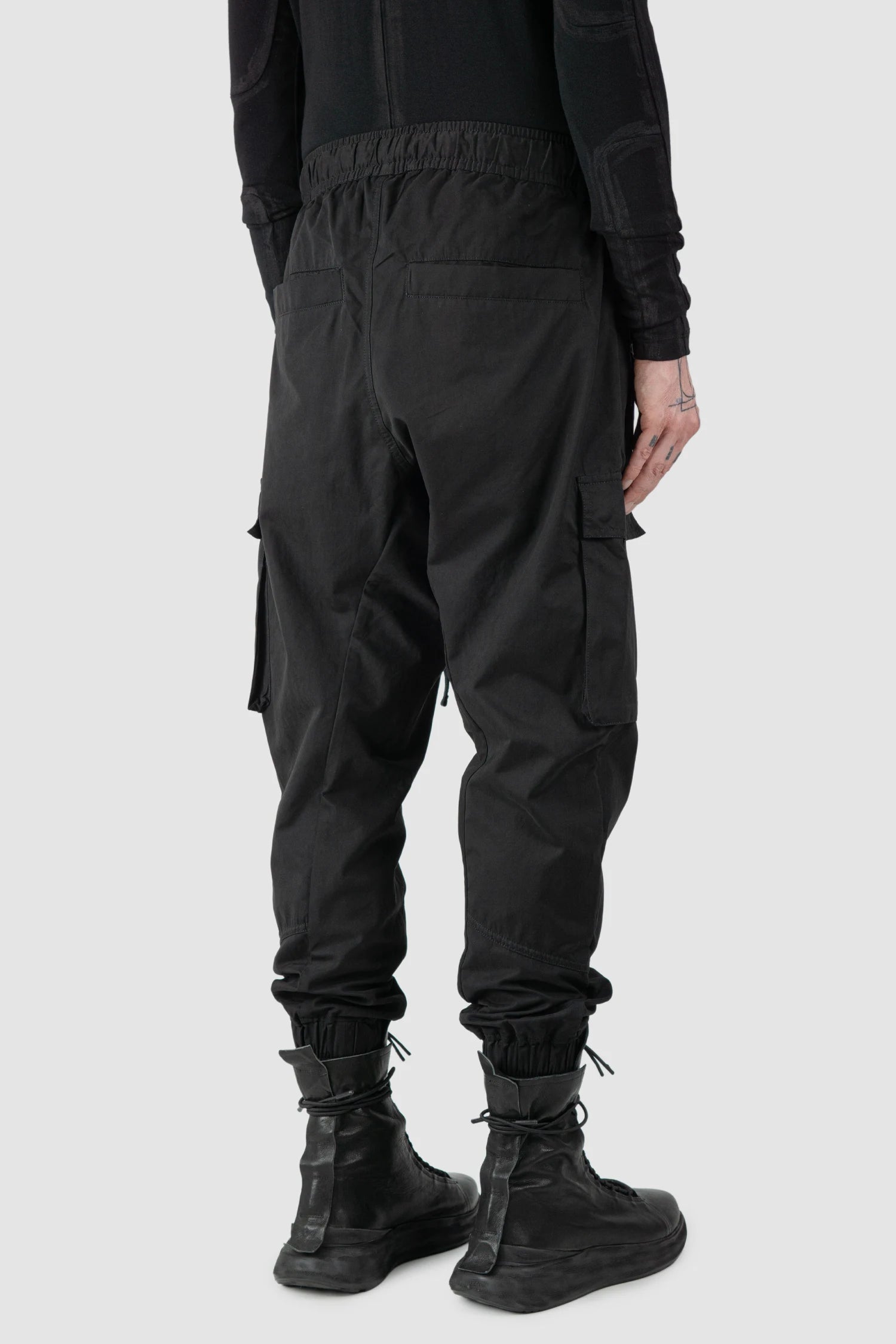 Thom Krom - model back side view of men’s FW25 Black Peached Cotton Cargo Trousers with Magnetic Belt - M-P-15