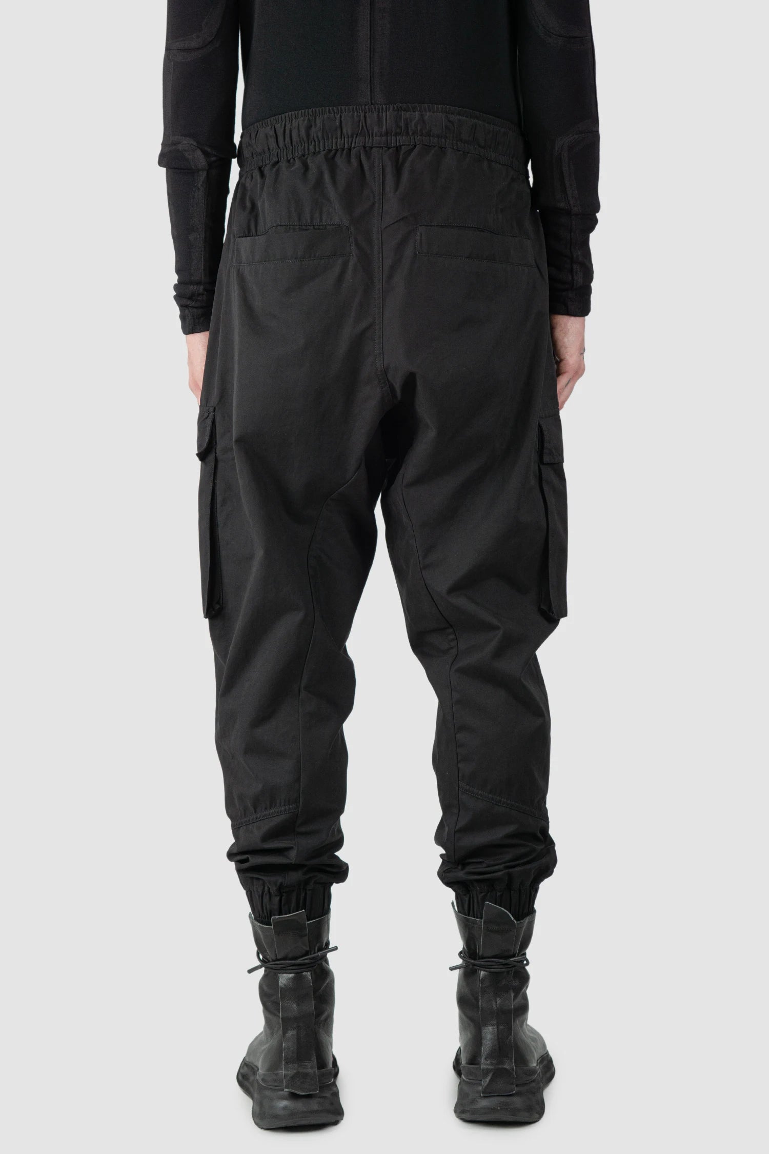 Thom Krom - model back view of men’s FW25 Black Peached Cotton Cargo Trousers with Magnetic Belt - M-P-15