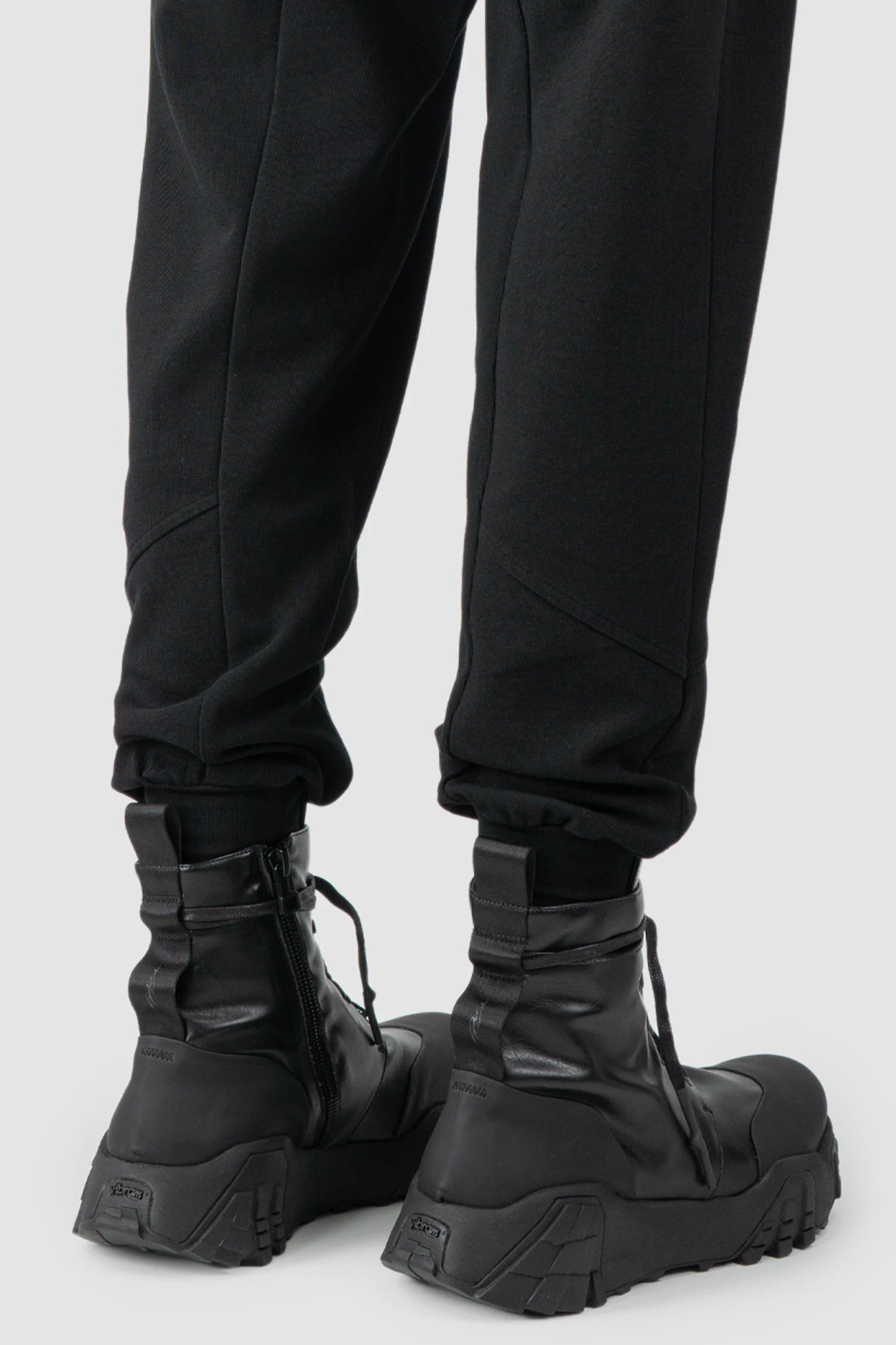Thom Krom - model back hem view of black Relaxed Fit Cotton Cargo Trousers with Zip Pockets - M-ST-509