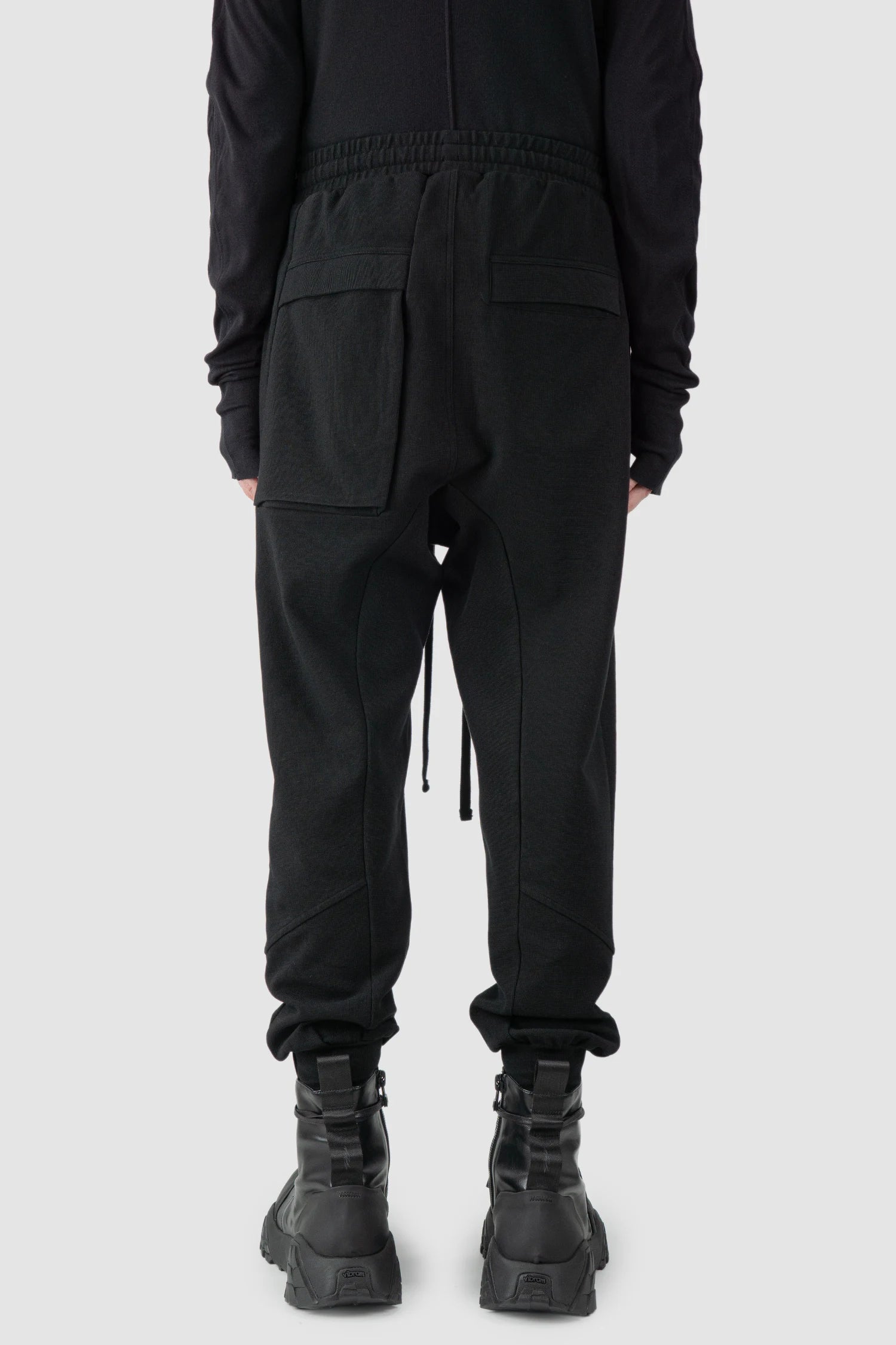 Thom Krom - model back view of black Relaxed Fit Cotton Cargo Trousers with Zip Pockets - M-ST-509