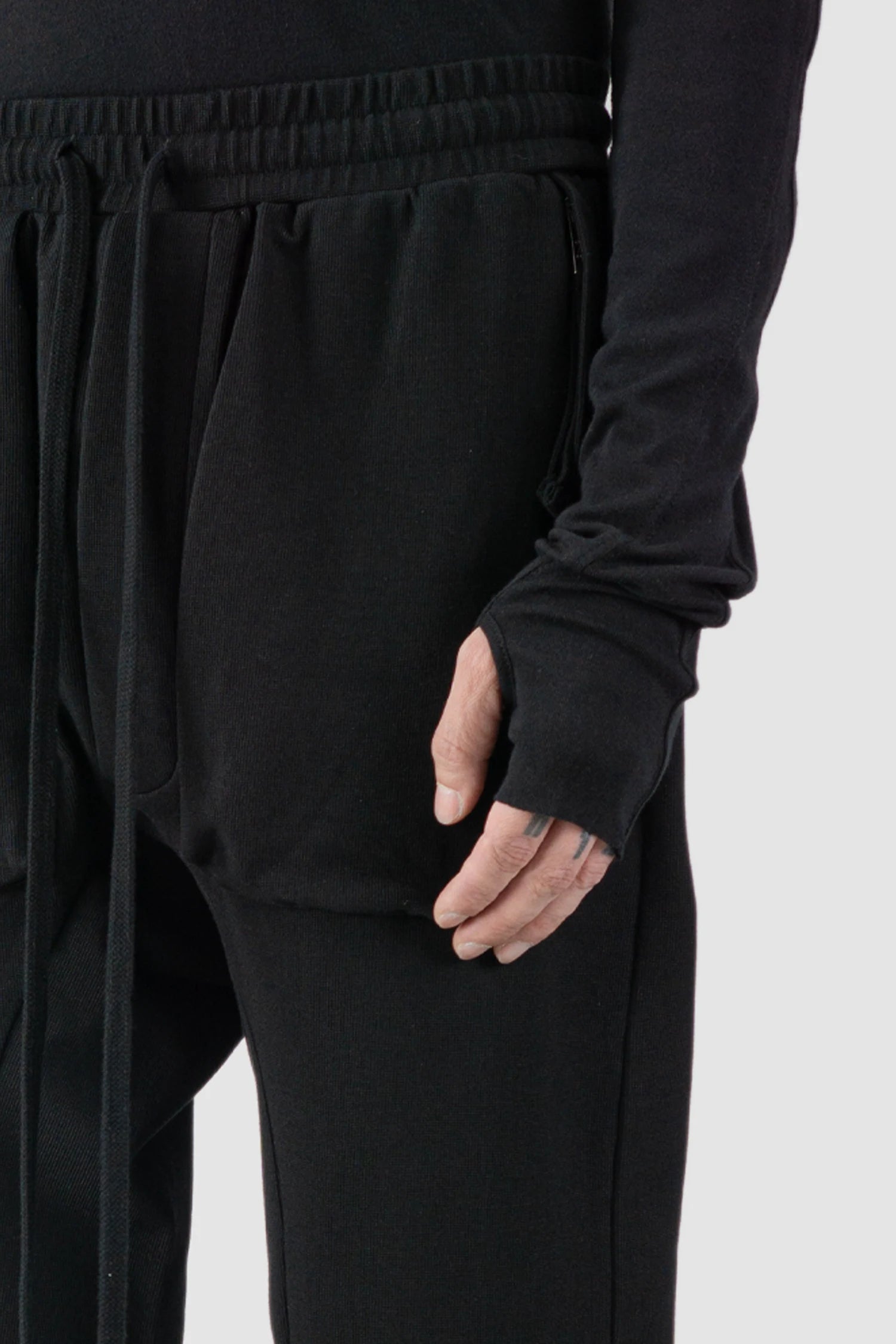 Thom Krom - model front detail view of black Relaxed Fit Cotton Cargo Trousers with Zip Pockets - M-ST-509
