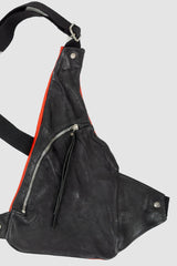 0.Hide - right detail view of vegetable tanned black and red horsehide leather cargo vest from the permanent collection with two types of horse leather shoulder panels, adjustable cotton straps and zippered pockets.