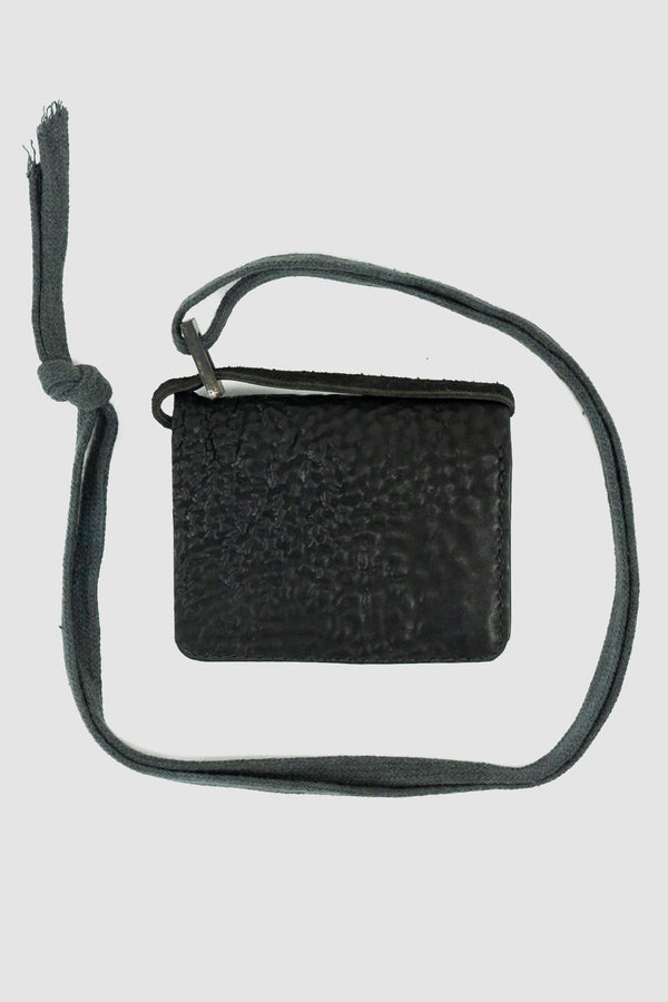 0.Hide - front solo view of vegetable tanned black cordovan shell leather snap holder wallet from the permanent collection with 4 card slots, branded metal details and cotton straps.