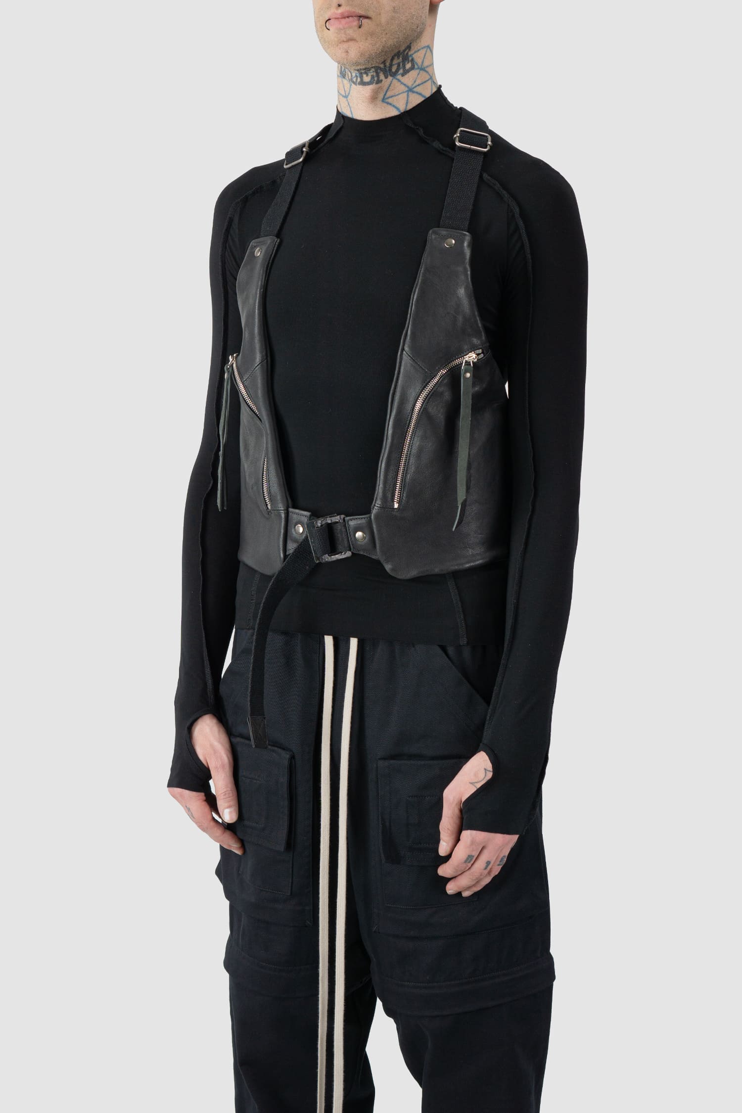 0.Hide - side person view of the black Horse Leather Cargo Vest Bag from the Permanent Collection.