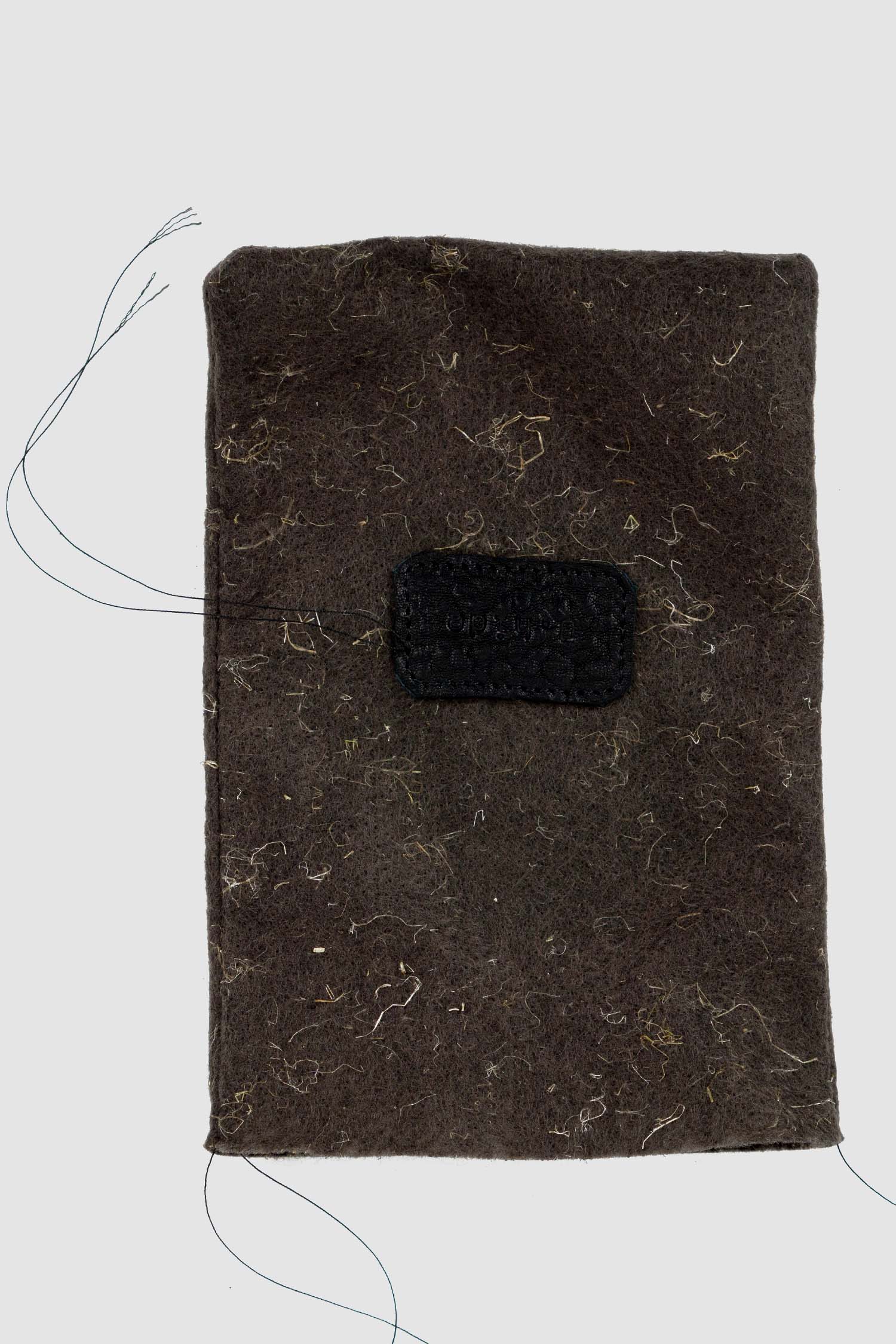 0.Hide - packing view of black leather Essential Messenger Bag.