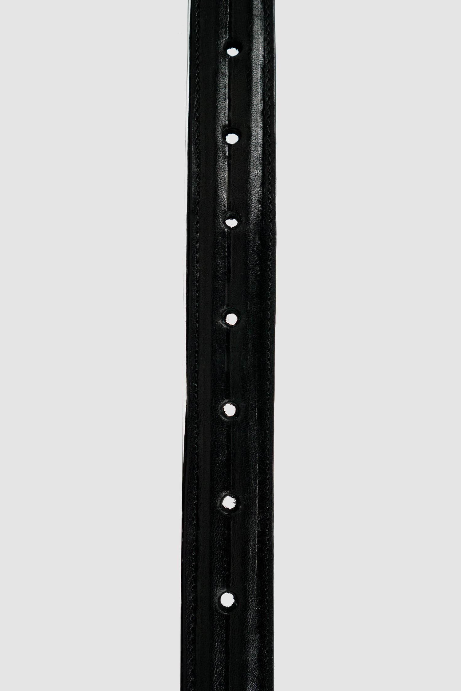 0.Hide - holes detail view of Vegetable Tanned Black Italien Bull Leather Metal Wire Belt. From the Permanent Collection with Steel Buckle detail.