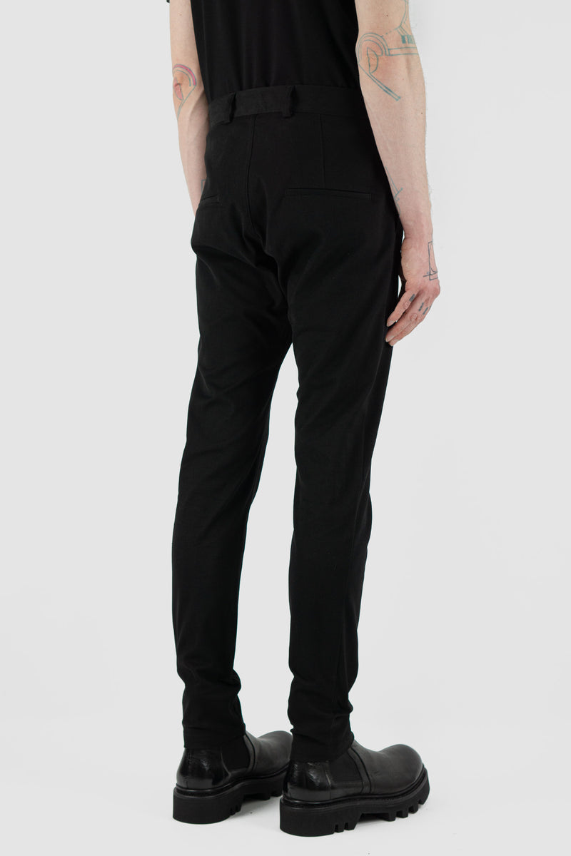 NOMEN NESCIO Black Slim Trousers (SS24) - 67% Organic Cotton, 30% Tencel, 3% Elastane. Features slanted front pockets, zip-fly fastening, and a soft, slightly elastic fabric. Stylish stitch fold detail, tapering towards the ankle. Two welt pockets on the back. Made in Estonia. Model is wearing size S (182 CM | 63 KG). Product Code: 205P Slim Trousers.