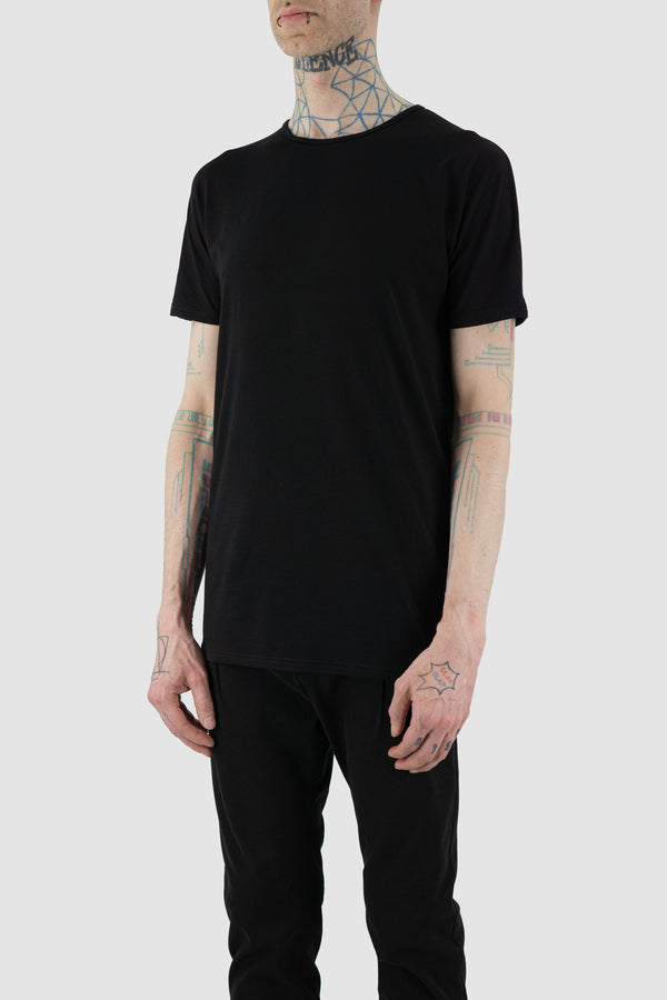 Discover the NOMEN NESCIO Black Basic T-Shirt from the SS24 Collection, a breathable and soft essential with a regular fit and round neckline. Crafted from 90% Ecovero and 10% Elastane, this versatile tee boasts a long hem and is proudly made in Estonia. Model is wearing size S (182 CM | 63 KG). Product Code: 408 Basic T-Shirt.
