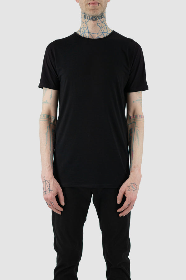 Discover the NOMEN NESCIO Black Basic T-Shirt from the SS24 Collection, a breathable and soft essential with a regular fit and round neckline. Crafted from 90% Ecovero and 10% Elastane, this versatile tee boasts a long hem and is proudly made in Estonia. Model is wearing size S (182 CM | 63 KG). Product Code: 408 Basic T-Shirt.