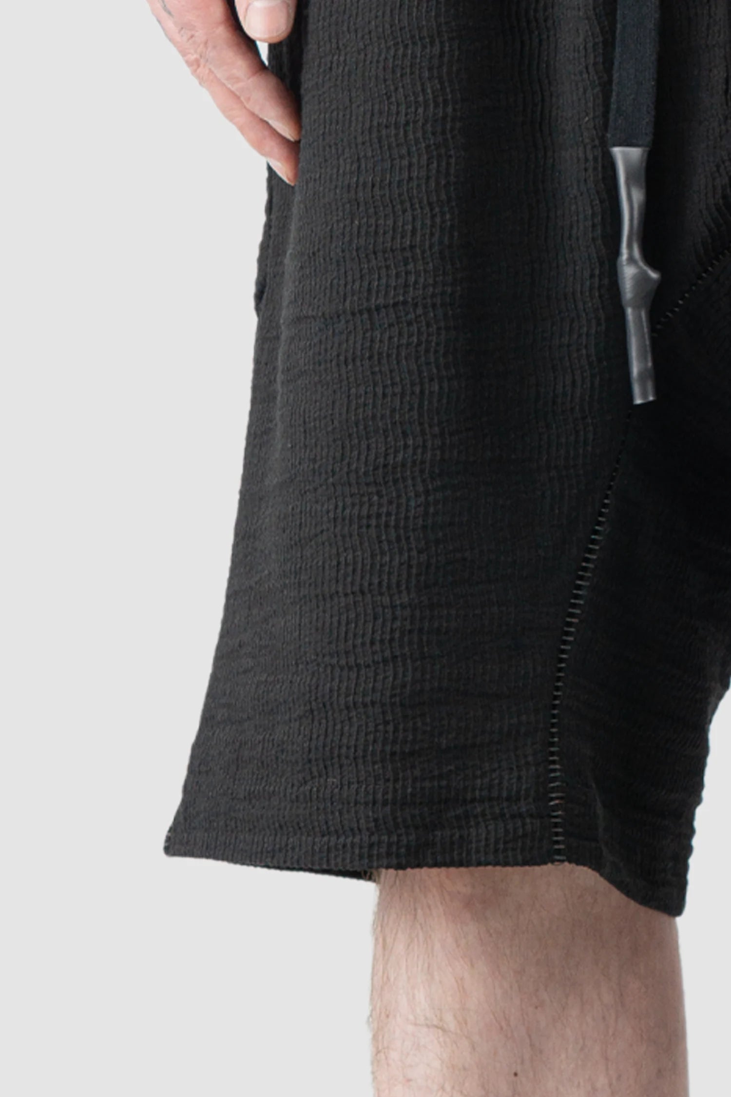 69 by Isaac Sellam - Men’s Black Drop Crotch Hidden Pocket Cotton Shorts hem detail view