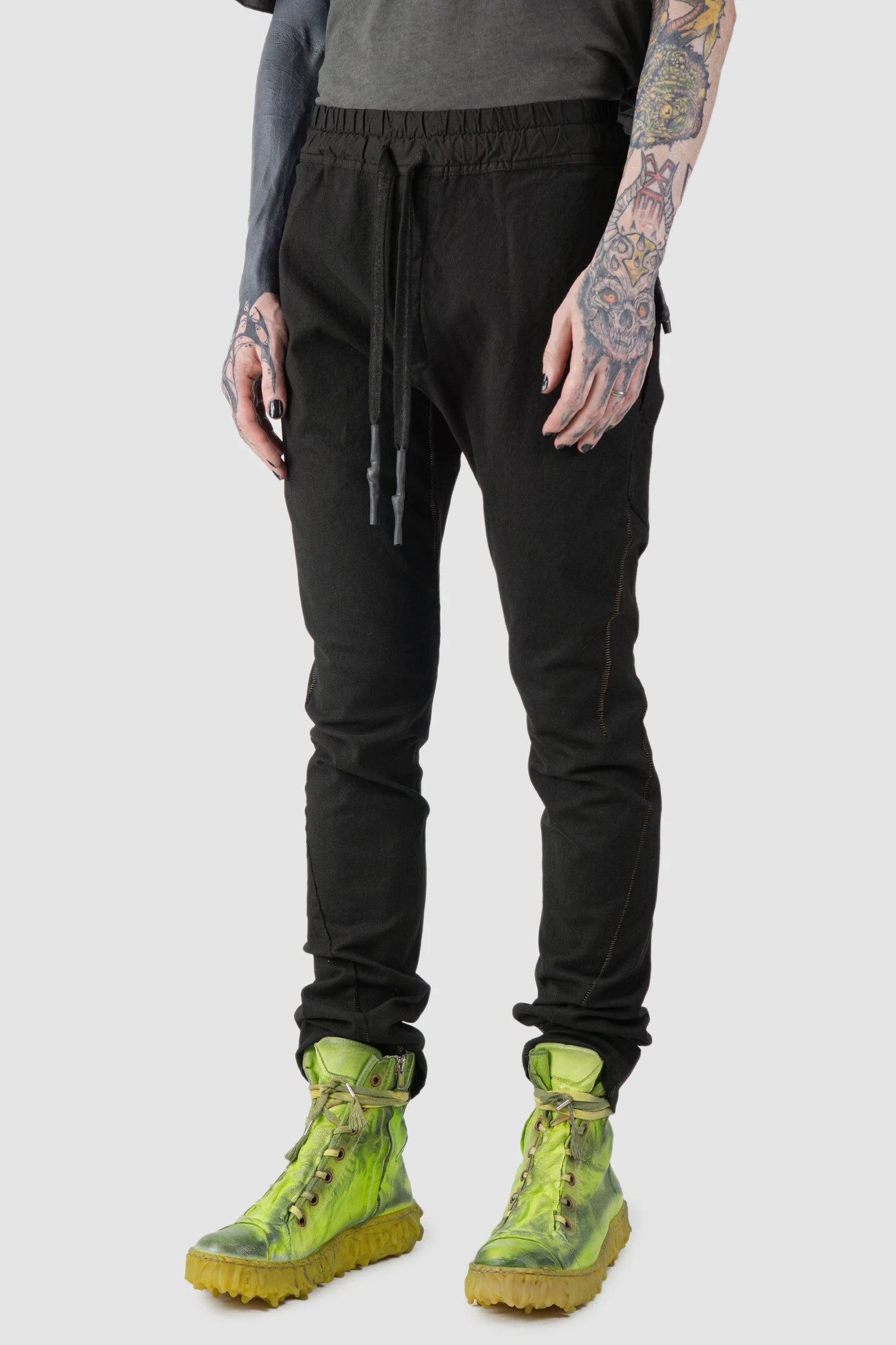 69 by Isaac Sellam - model front side view of Black Fitted Cotton Cargo Trousers