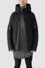 69 by Isaac Sellam - model front half open view of men’s Black Padded Cotton Jacket with Hood