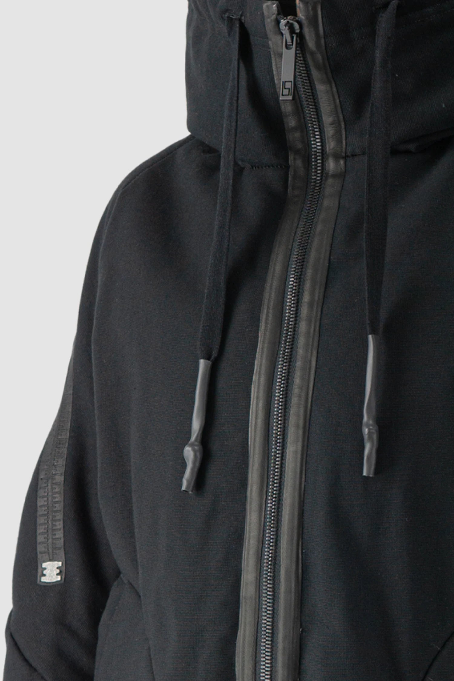 69 by Isaac Sellam - model front zipper detail view of men’s Black Padded Cotton Jacket with Hood
