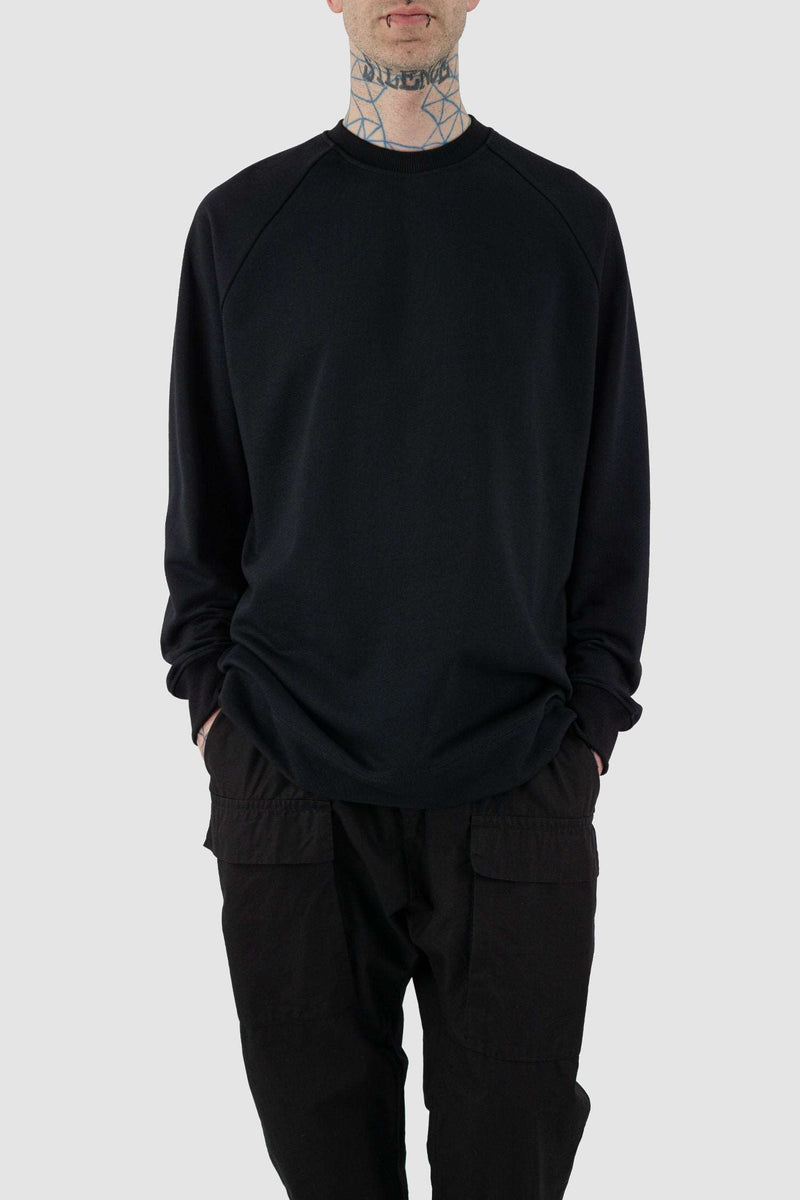 Close up view of Black Raglan Sweatshirt for Men with relaxed fit and wool rib details, SS24, NOMEN NESCIO