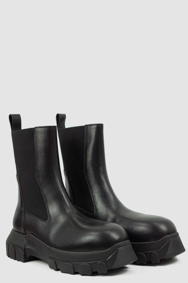 Rick Owens Black Bozo Tractor Boots for Men from the FW21 Collection with Elastic Rubber Band and pull tab Detail, front left.