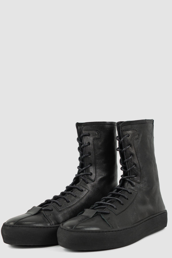 The Last Conspiracy Black Leather High Top Sneaker for Men from SS24 Collection with Excella Back Zip Detail. Color: Black | Material: 100% Horse Leather, Vegetal Black Tanned Leather | Ankle High