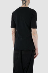 First Aid to the Injured - back side view of black cotton T-Shirt with asymmetrical stitching for men from the FW24 collection with decorative flatlock seams on the body and shoulders.