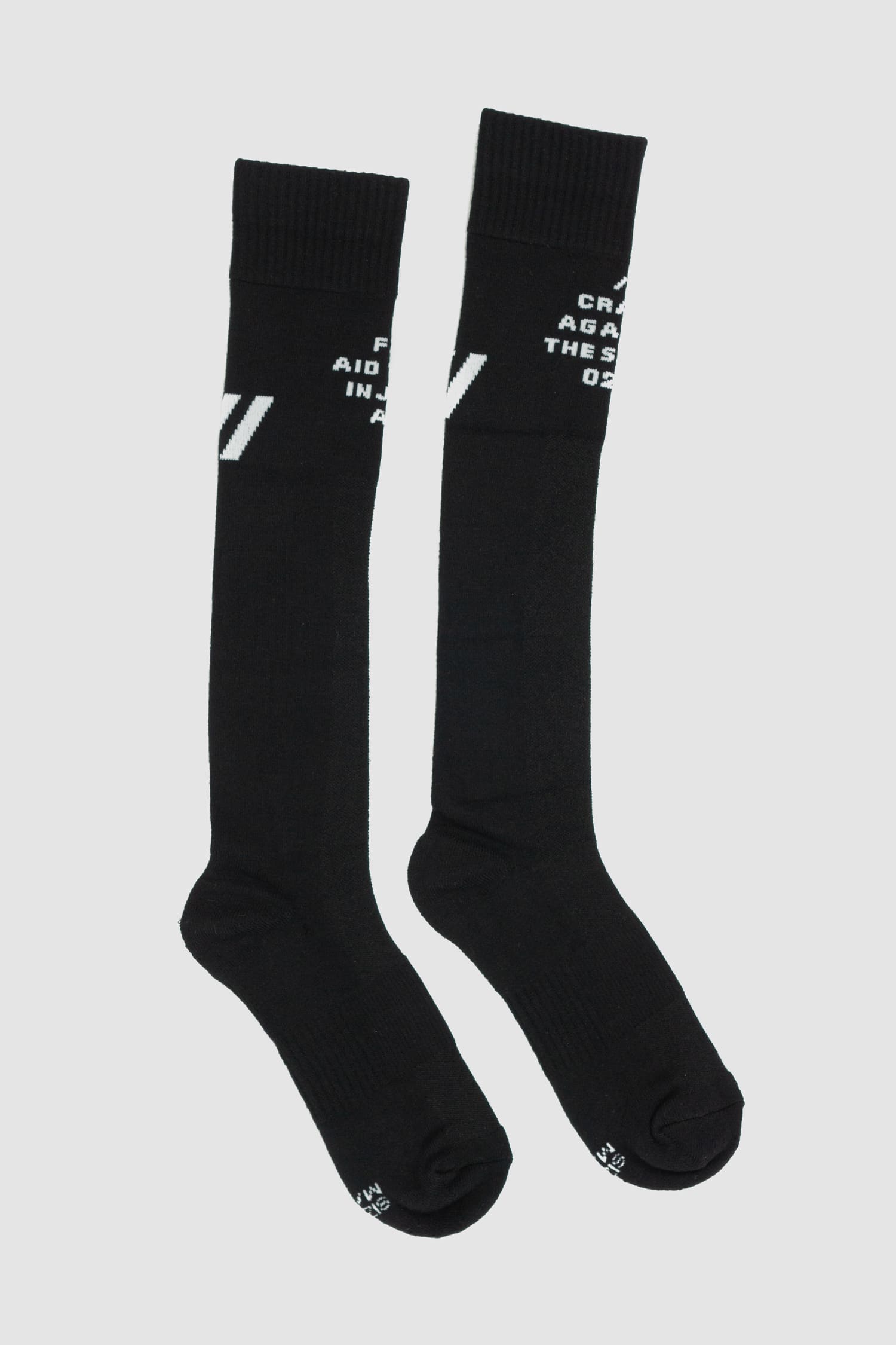 First Aid to the Injured - right view of black "Crash against the shore" logo socks from the FW24 collection with contrasted branding and knee-high design.