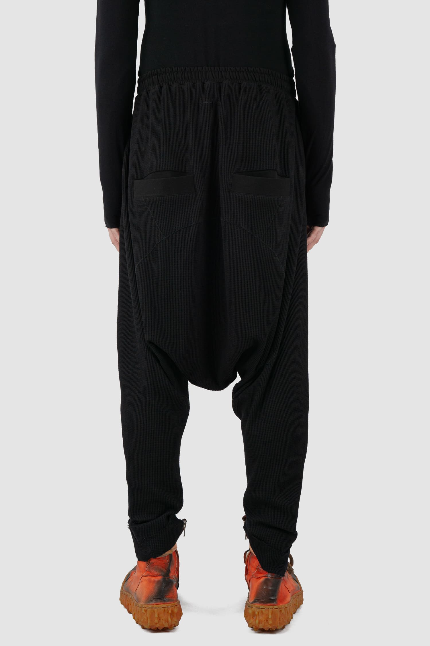 First Aid to the Injured - back view of black drop crotch waffle cotton joggers for men from the FW24 collection with elastic waistband and drawstring as well as 2 back and 2 side pockets.