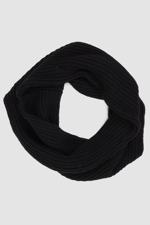 First Aid to the Injured - solo front view of black knitted round wool blend scarf from the FW24 collection made from soft 3GG knit. This scarf promises to keep you cozy and stylish throughout the winter season.