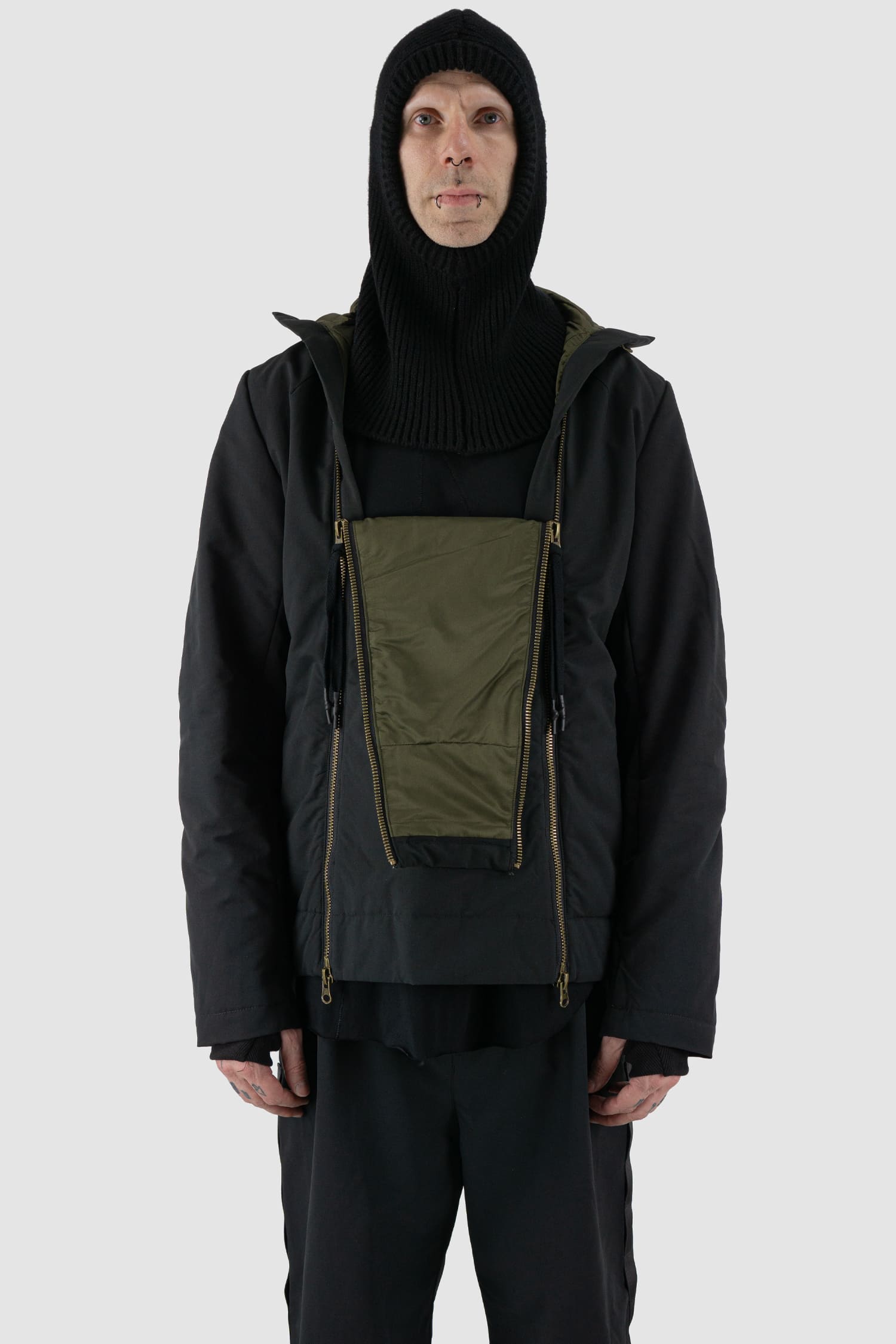 First Aid to the Injured - front view of black knitted wool blend balaclava hood from the FW24 collection with extra length, which can also be worn as a loop scarf and neck warmer.