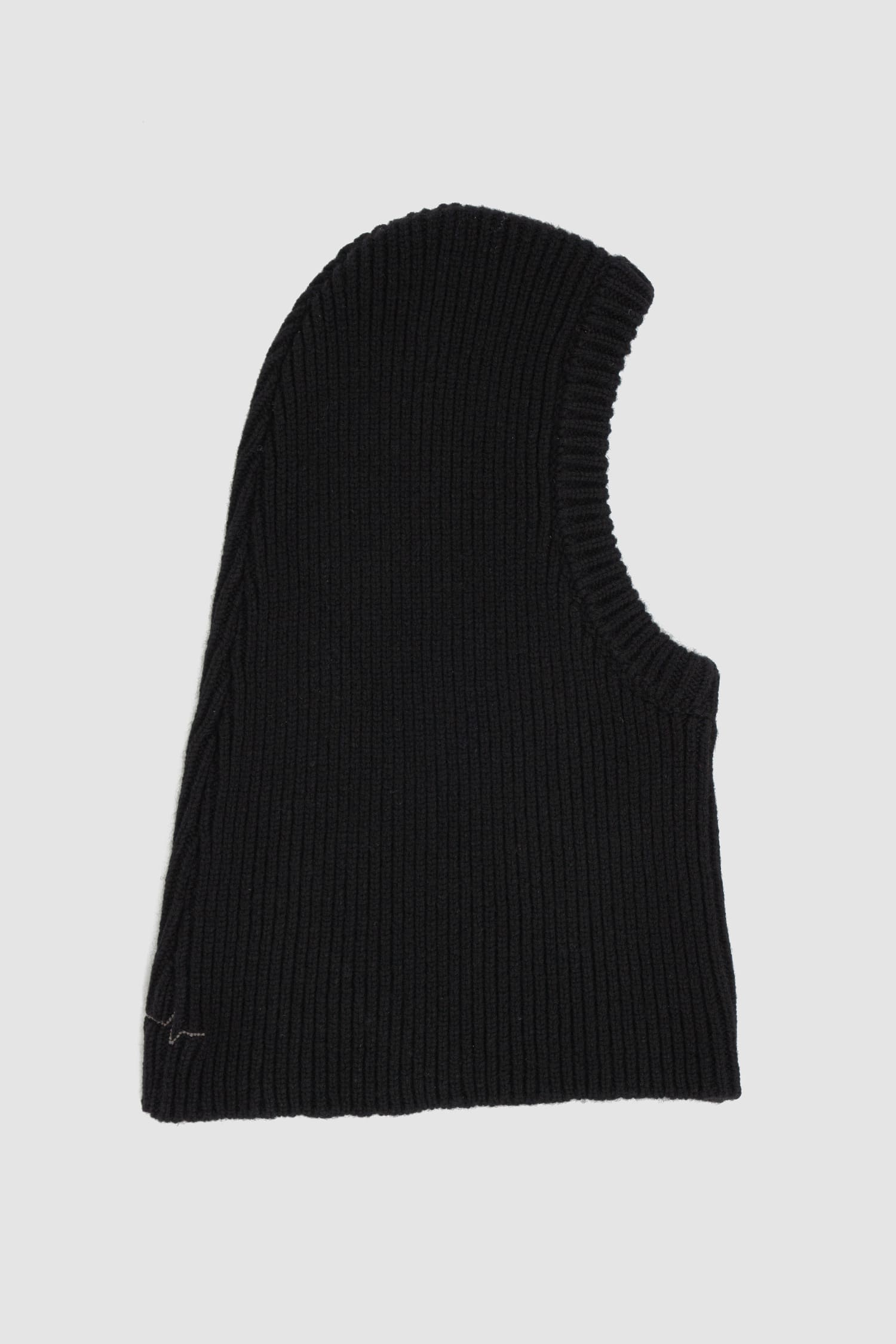 First Aid to the Injured - solo left view of black knitted wool blend balaclava hood from the FW24 collection with extra length, which can also be worn as a loop scarf and neck warmer.