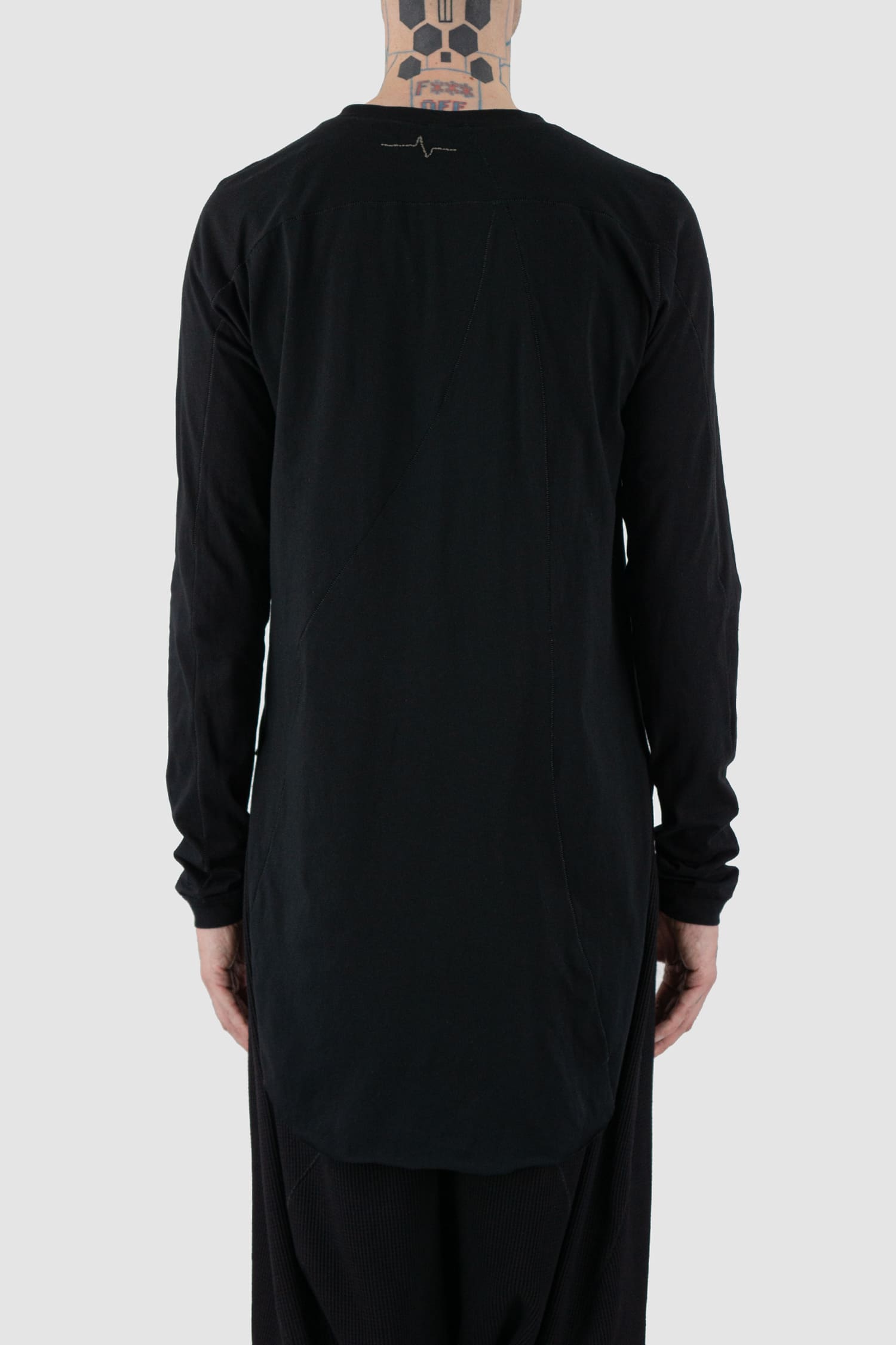 First Aid to the Injured -  back view of black long sleeve T-Shirt with rounded hem for men from the FW24 collection with long back, side slit and decorative flatlock seams.