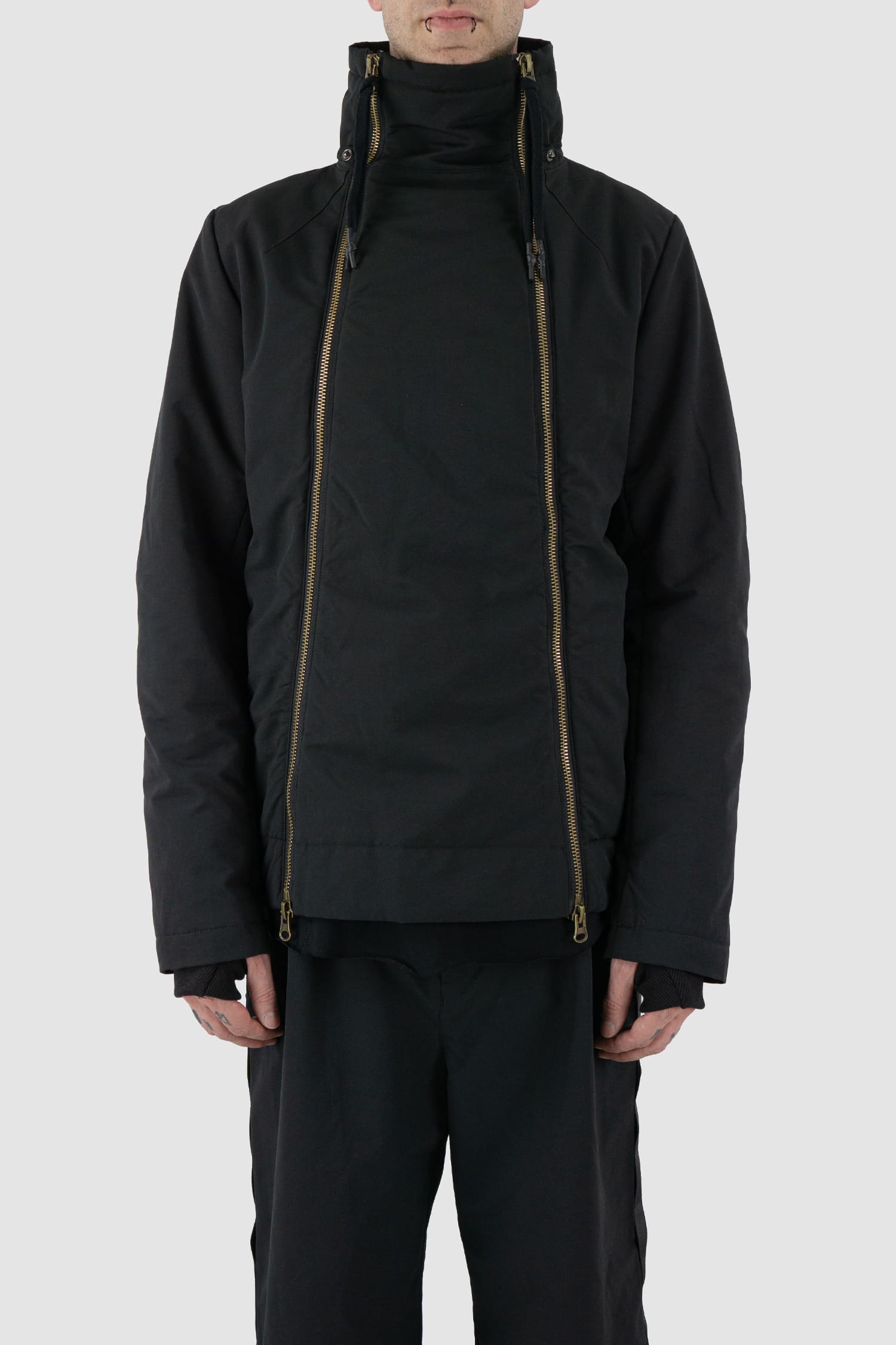 First Aid to the Injured - front no hood  view of black padded jacket with double zipper closure for men from the FW24 collection with detachable hood, 2 long zippers to close the jacket and knitted-in cuffs with thumb holes.