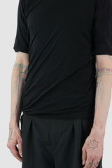 First Aid to the Injured - hem detail view of black twisted double layer jersey T-Shirt for men from the FW24 collection featuring a distinctive twisting bottom and sleeves crafted in a double layer of thin jersey and a center back seam.