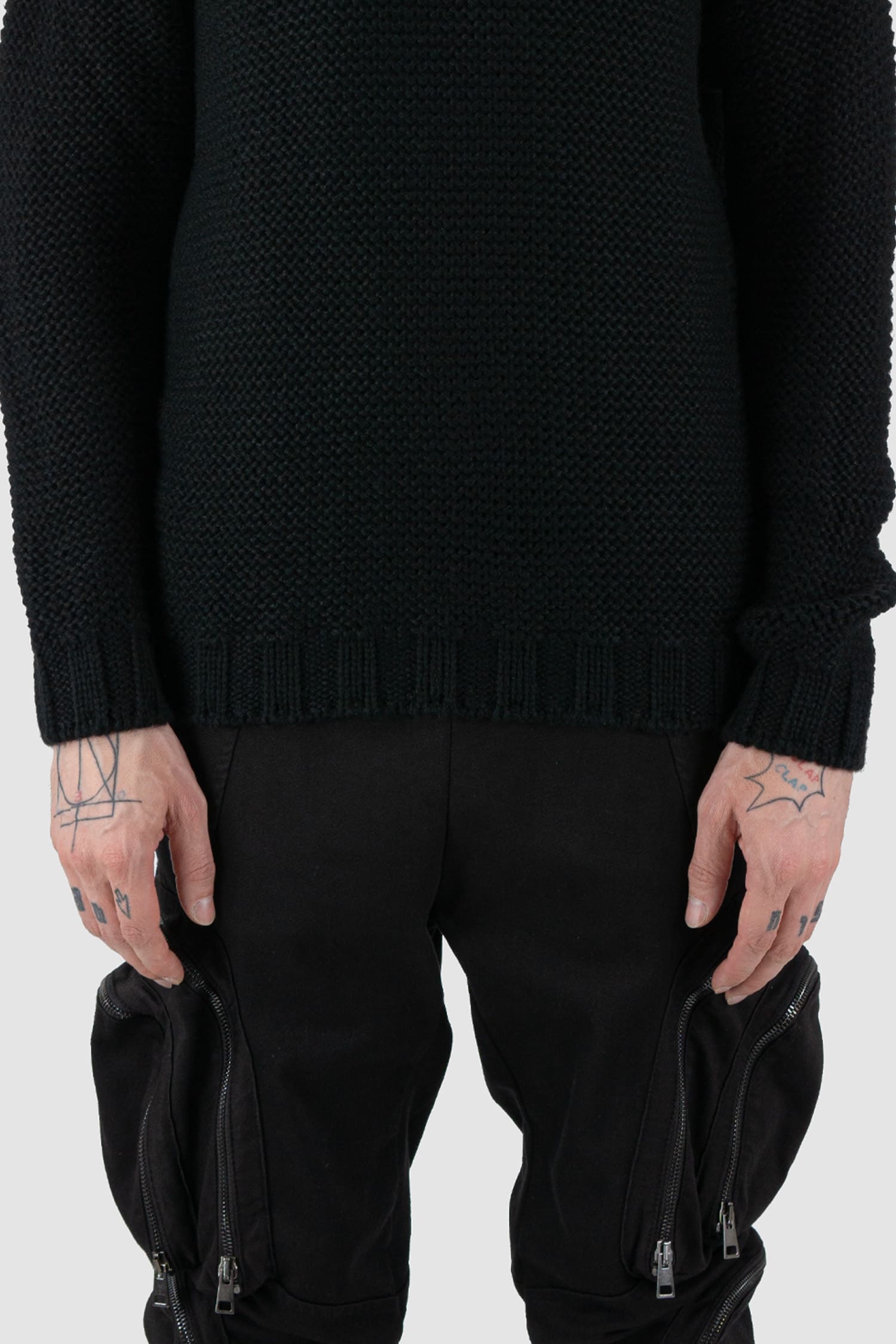 La Haine Inside Us - front detail view of black high neck waffle knit sweater for men from the FW24 collection with a solid, thicker neck, dropped shoulders and a straight fit.
