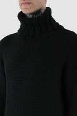 La Haine Inside Us - front side detail view of black high neck waffle knit sweater for men from the FW24 collection with a solid, thicker neck, dropped shoulders and a straight fit.