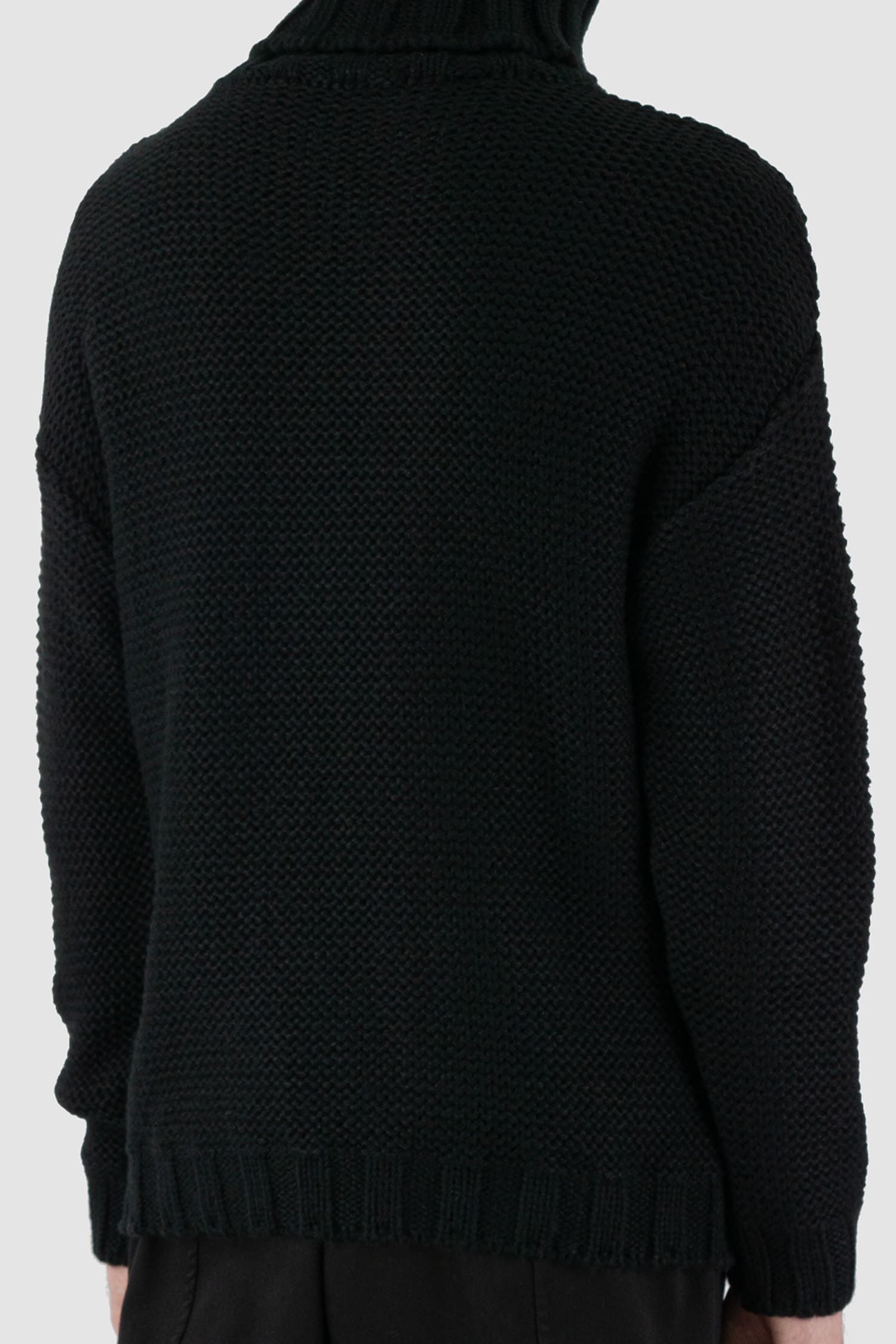 La Haine Inside Us - back detail view of black high neck waffle knit sweater for men from the FW24 collection with a solid, thicker neck, dropped shoulders and a straight fit.