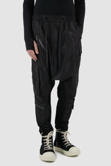 La Haine Inside Us - legere front view of black nylon trousers with low crotch for men from the FW24 collection with knitted inner seams and elastic waistband.