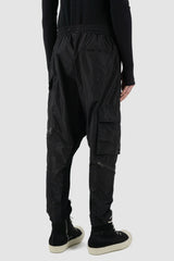 La Haine Inside Us - back side view of black nylon trousers with low crotch for men from the FW24 collection with knitted inner seams and elastic waistband.