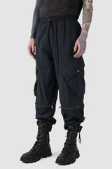 La Haine Inside us - front right side view of Black Utility Transform Cargo Pocket Trousers