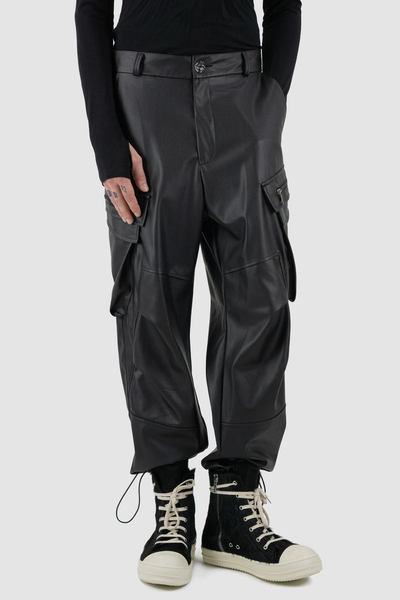 La Haine Inside Us - Front legere view of black men's vegan leather cargo pants with belt loops, adjustable drawstring at bottom hem, FW24 collection.