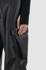 La Haine Inside Us - Front detail view of black men's vegan leather cargo pants with belt loops, adjustable drawstring at bottom hem, FW24 collection.