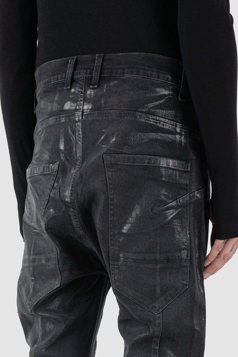 La Haine Inside Us - back detail view of black men's coated slim fit jeans with stretch cotton denim, patch pockets, FW24 collection.