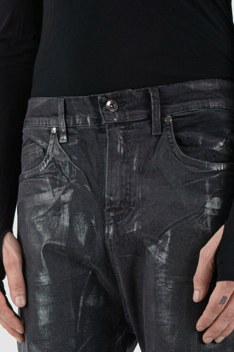 La Haine Inside Us - Front detail view of black men's coated slim fit jeans with stretch cotton denim, patch pockets, FW24 collection.