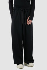 La Haine Inside Us - Front legere view of black men's wide-leg cropped viscose blend trousers with low crotch, adjustable waistband, FW24 collection.