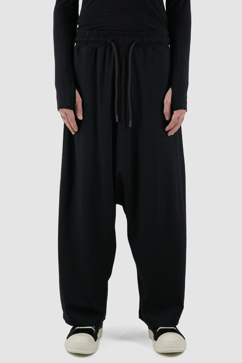 La Haine Inside Us - Front view of black men's wide-leg cropped viscose blend trousers with low crotch, adjustable waistband, FW24 collection.