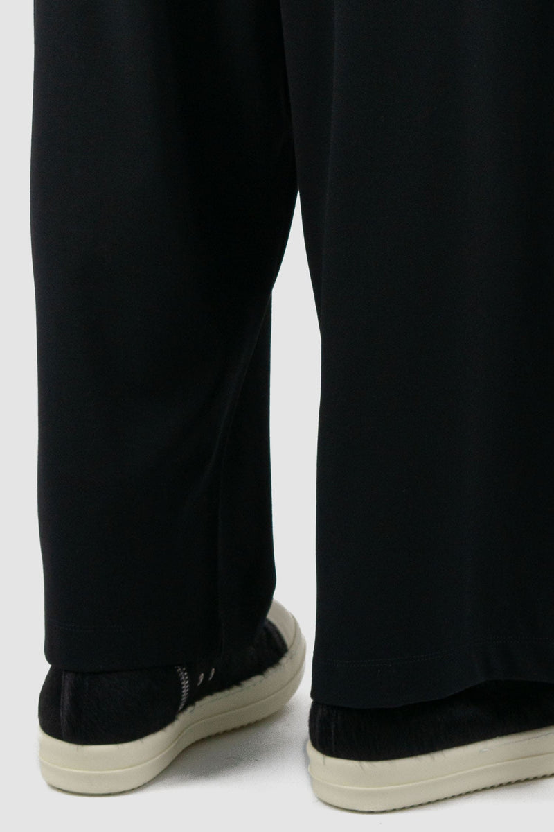 La Haine Inside Us - hem view of black men's wide-leg cropped viscose blend trousers with low crotch, adjustable waistband, FW24 collection.