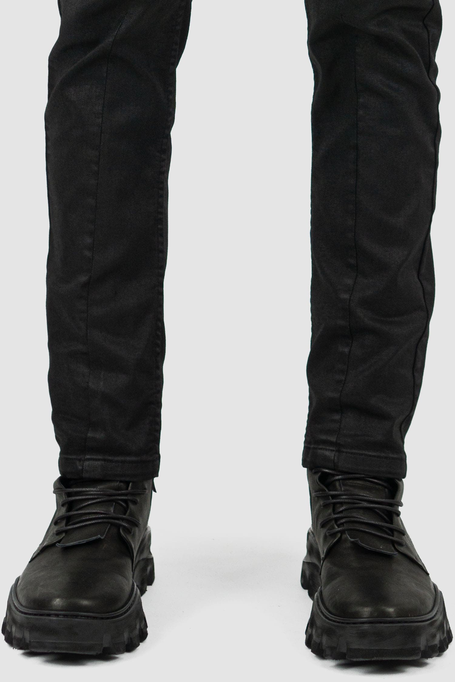 Leon Louis - hem view of black waxed dart cut denim jeans, five pockets, slim fit, men's Permanent Collection.