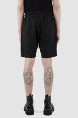 Nomen Nescio - back view of black light field shorts with elastic waistband, slanted side pockets.