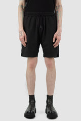 Nomen Nescio - Front view of black light field shorts with elastic waistband, slanted side pockets.