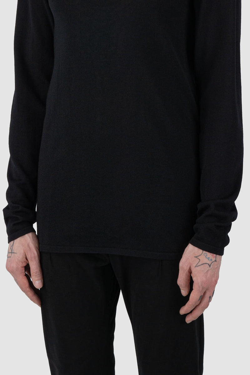 Nomen Nescio - front hem view of black merino wool turtleneck sweater 505 for men from the FW24 collection is crafted from 100% fine merino wool and features mulesing-free yarn.