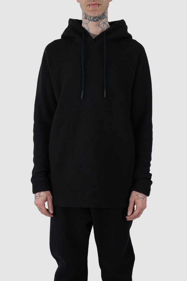 Nomen Nescio - front view of black recycled wool hoodie 518 for men from the FW24 collection offers a roomy fit with a large hood and wool rib details on the hem and cuffs.