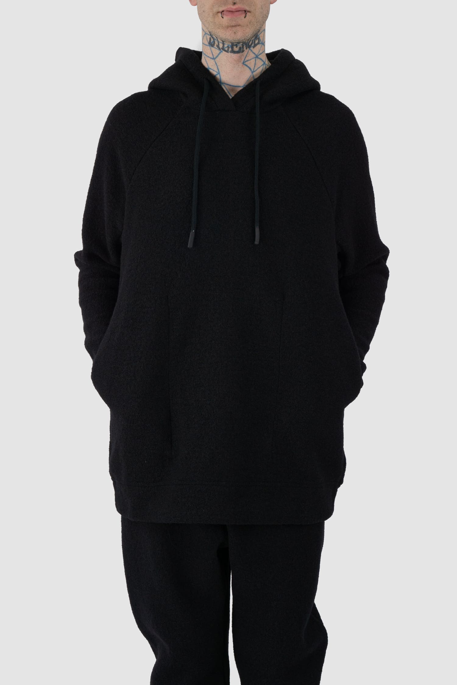 Nomen Nescio - front relaxed view of black recycled wool hoodie 518 for men from the FW24 collection offers a roomy fit with a large hood and wool rib details on the hem and cuffs.