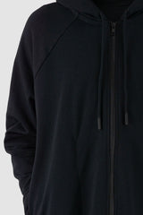 Nomen Nescio - Front detail view of black raglan zip hoodie with wool rib cuffs, relaxed fit.